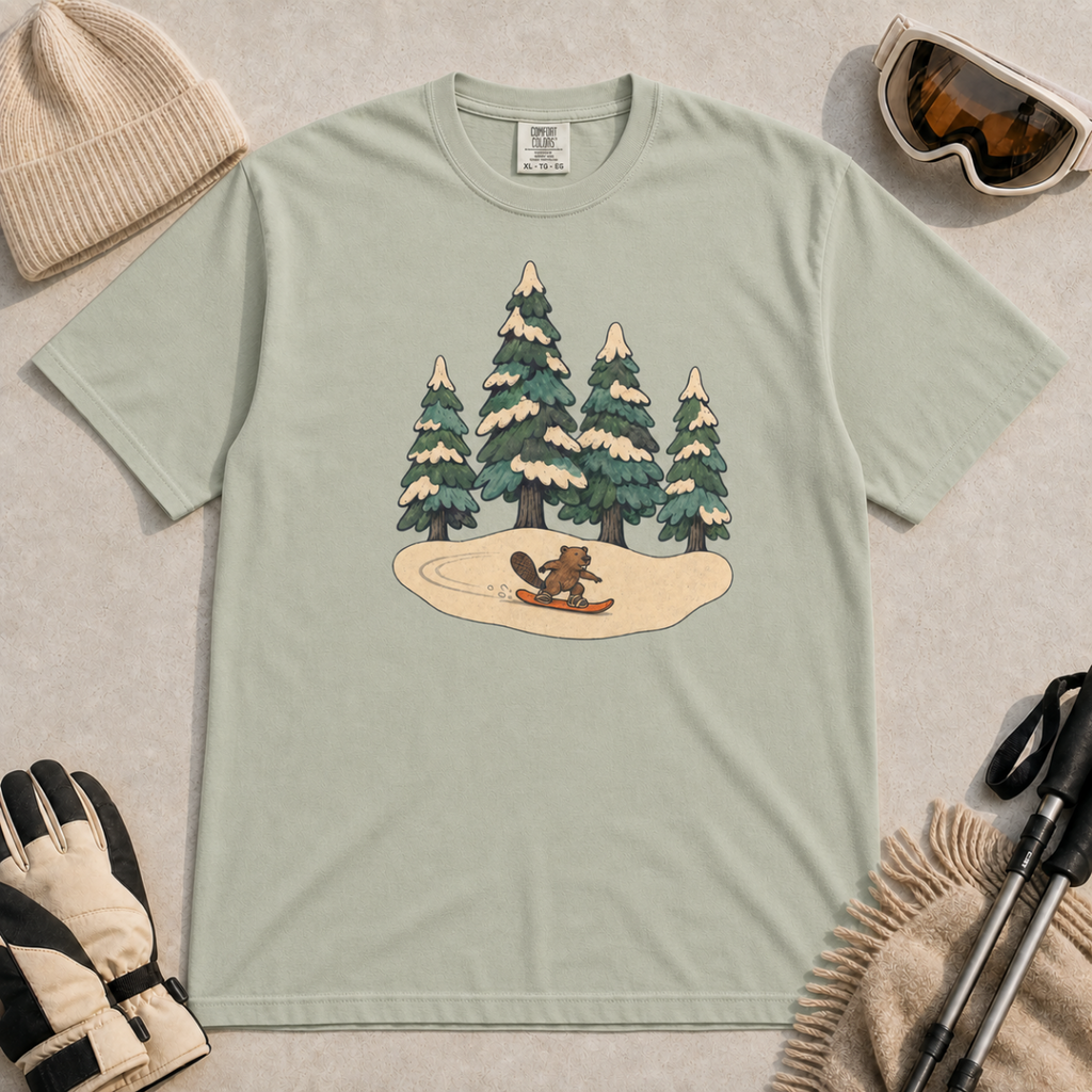 Bay green t-shirt featuring a small beaver snowboarding beneath four snow-covered pine trees.