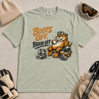 Bay green t-shirt featuring a marmot relaxing on a bench with ski gear and the words “Boots Off, Brain Off.”