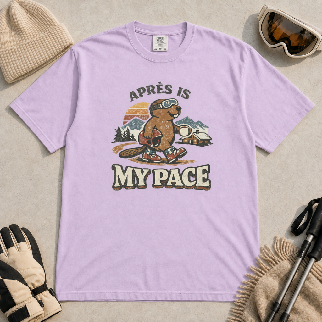 Orchid purple t-shirt featuring a beaver in ski boots holding a mug beneath the words “Après Is My Pace.”