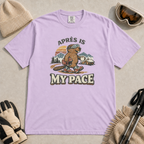 Orchid purple t-shirt featuring a beaver in ski boots holding a mug beneath the words “Après Is My Pace.”