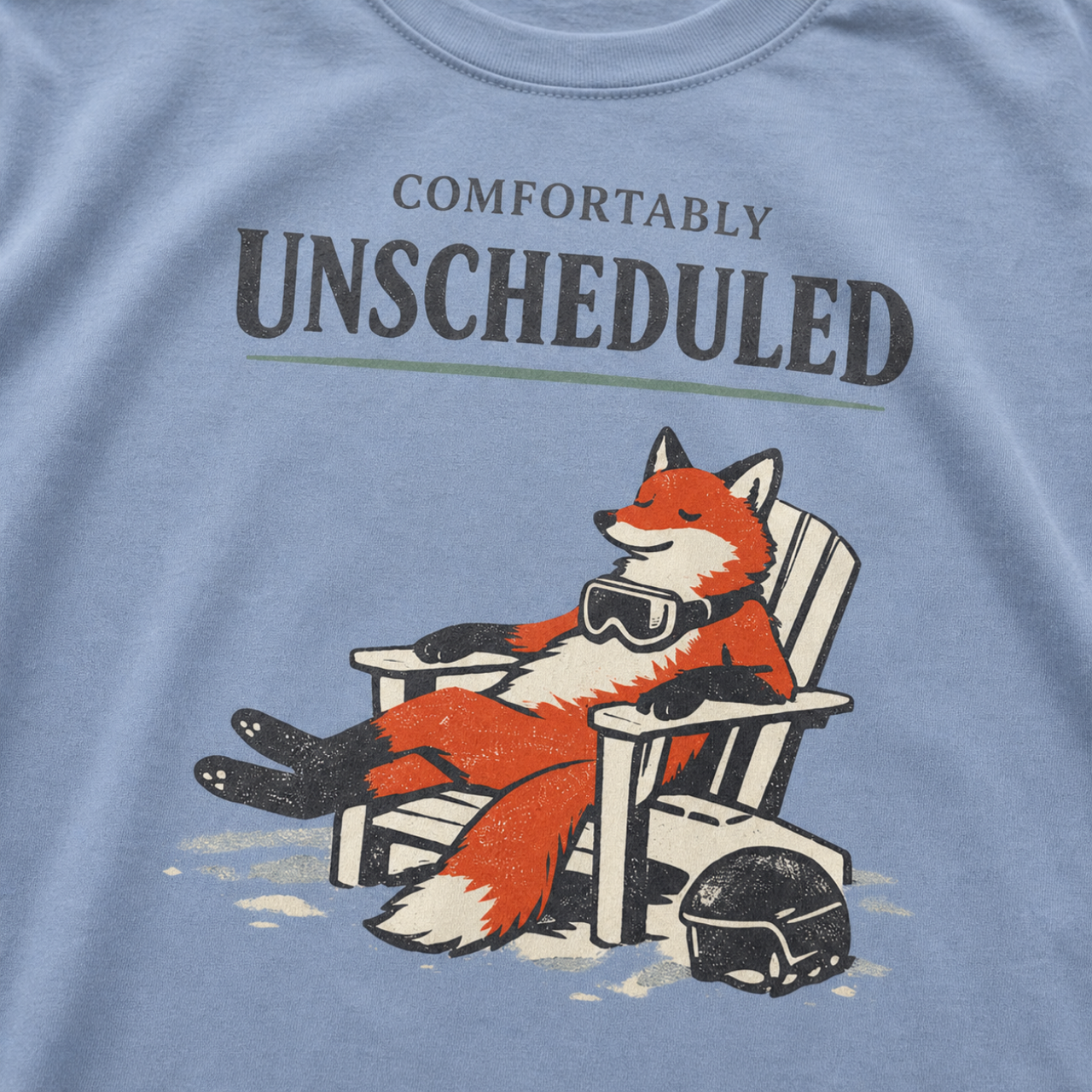 Close-up of a relaxed fox wearing ski goggles in a chair with the words “Comfortably Unscheduled.”