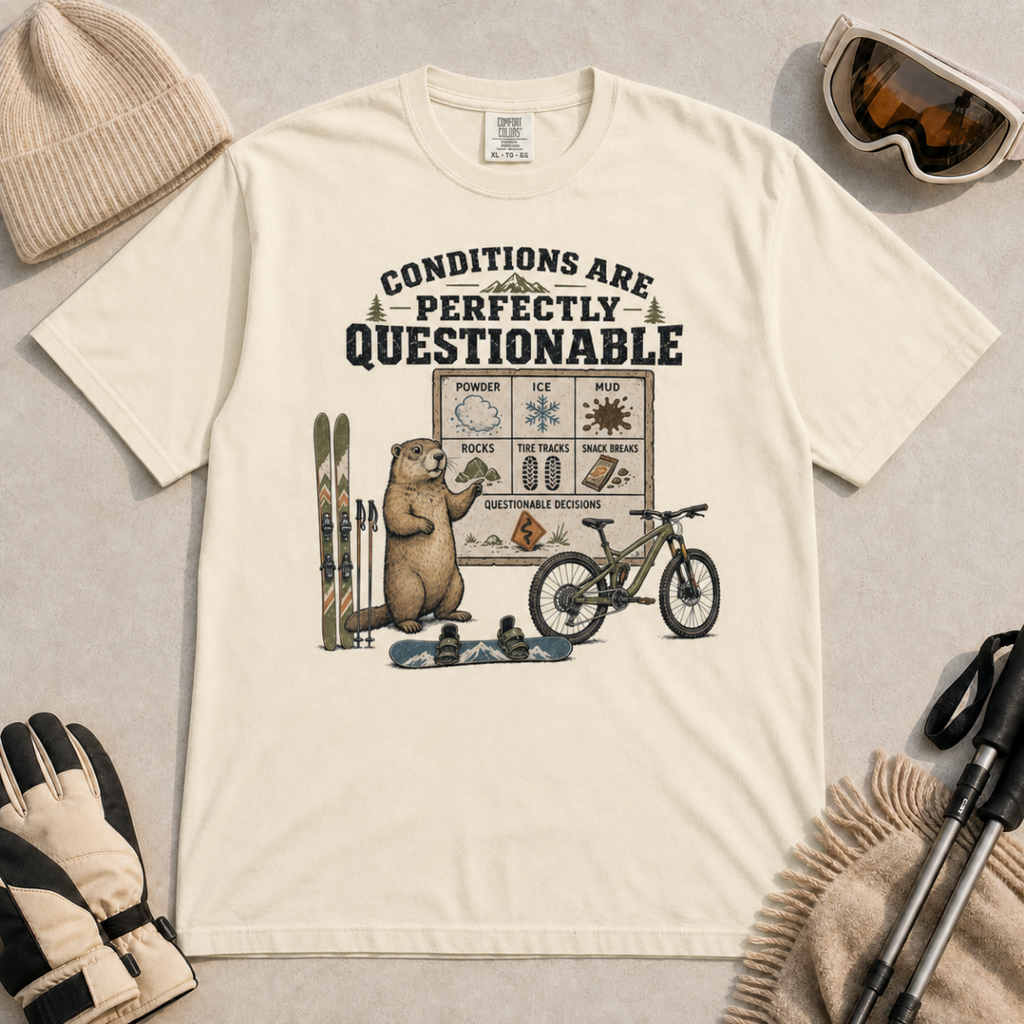 Ivory white t-shirt featuring a marmot with skiing, snowboarding, and mountain biking gear under “Conditions Are Perfectly Questionable” text.