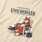 Close-up of a relaxed fox wearing ski goggles in a chair with the words “Comfortably Unscheduled.”