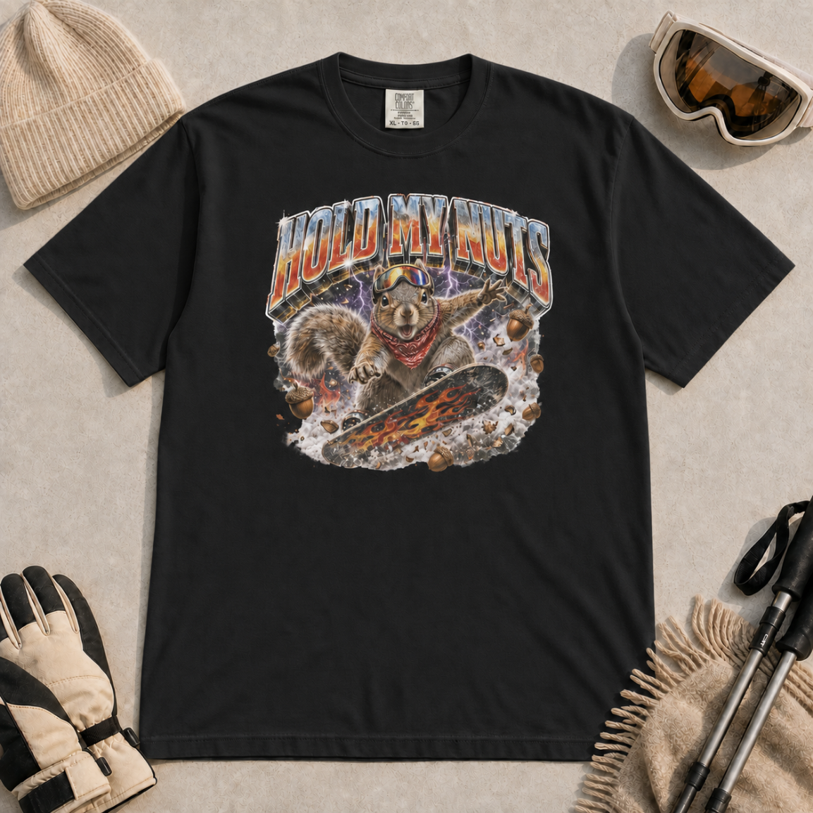 Black gray t-shirt featuring a squirrel snowboarding through flying acorns beneath the words “Hold My Nuts.”