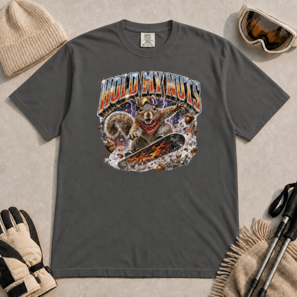 Pepper gray t-shirt featuring a squirrel snowboarding through flying acorns beneath the words “Hold My Nuts.”