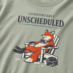 Close-up of a relaxed fox wearing ski goggles in a chair with the words “Comfortably Unscheduled.”