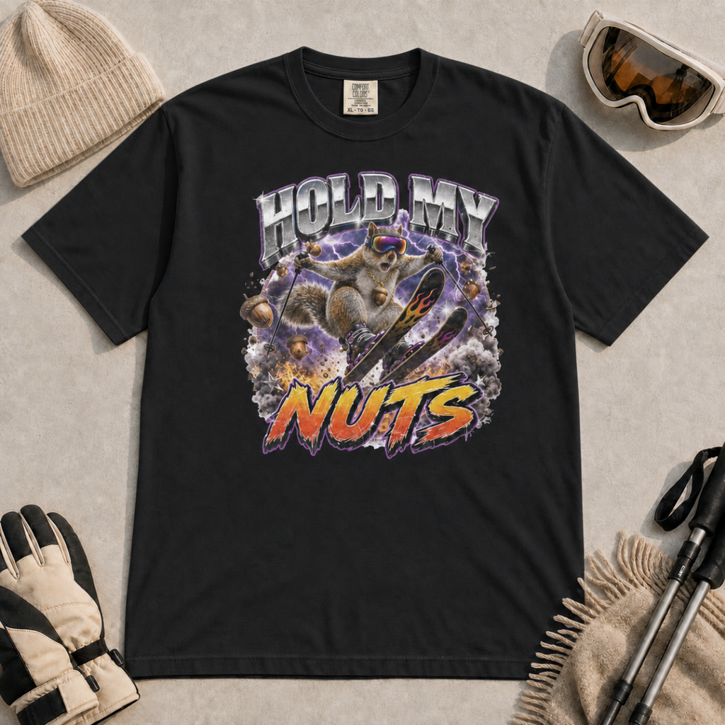 Black t-shirt featuring a squirrel performing an aerial ski trick beneath the words “Hold My Nuts.”