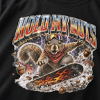 Close-up of a squirrel performing a snowboard trick amid purple lightning, snow, and acorns beneath the words “Hold My Nuts.”