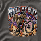 Close-up of a bold squirrel mountain biking design with lightning, flying acorns, and the words “Hold My Nuts” on a pepper gray t-shirt.