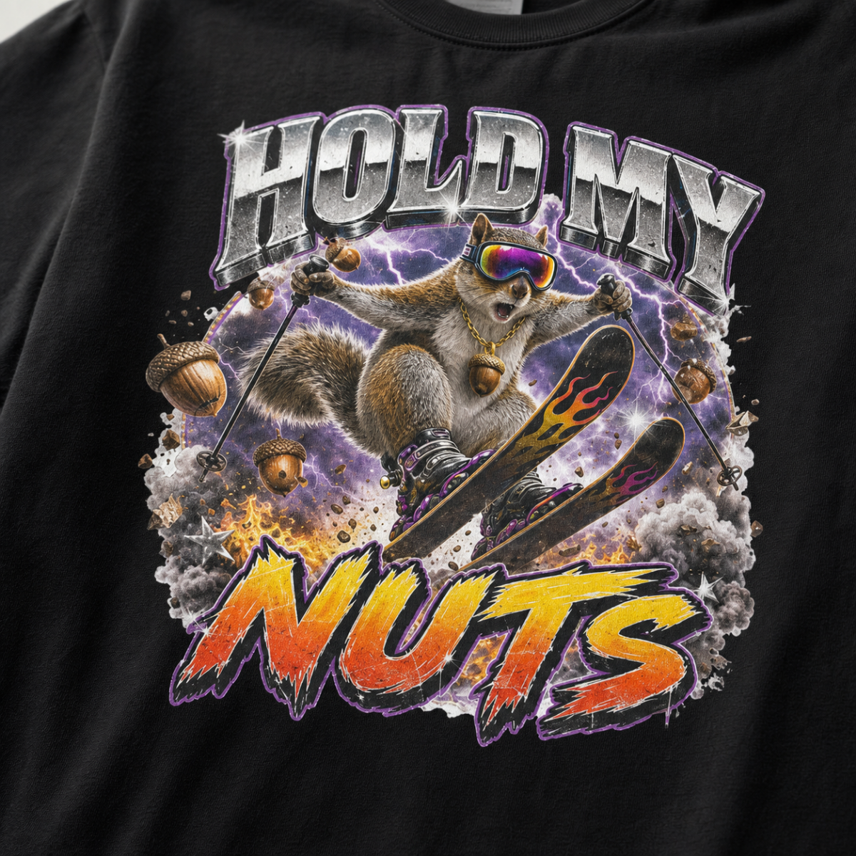 Close-up of a bold squirrel skiing design with purple lightning, flying acorns, and the words “Hold My Nuts” on a charcoal gray t-shirt.