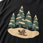Close-up of a small beaver snowboarding through a snowy evergreen forest on a black t-shirt.