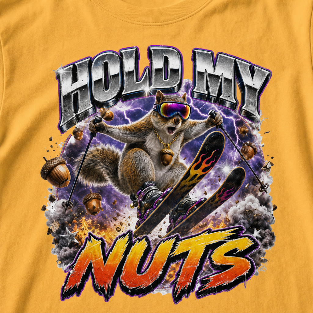 Close-up of a bold squirrel skiing design with purple lightning, flying acorns, and the words “Hold My Nuts” on a charcoal gray t-shirt.