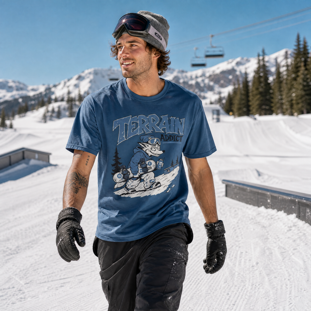 Person wearing a midnight blue t-shirt with 'Terrain' branding on a snowy mountain background