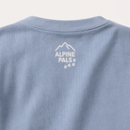 Washed denim blue shirt with 'Alpine Pals' logo on a light gray background