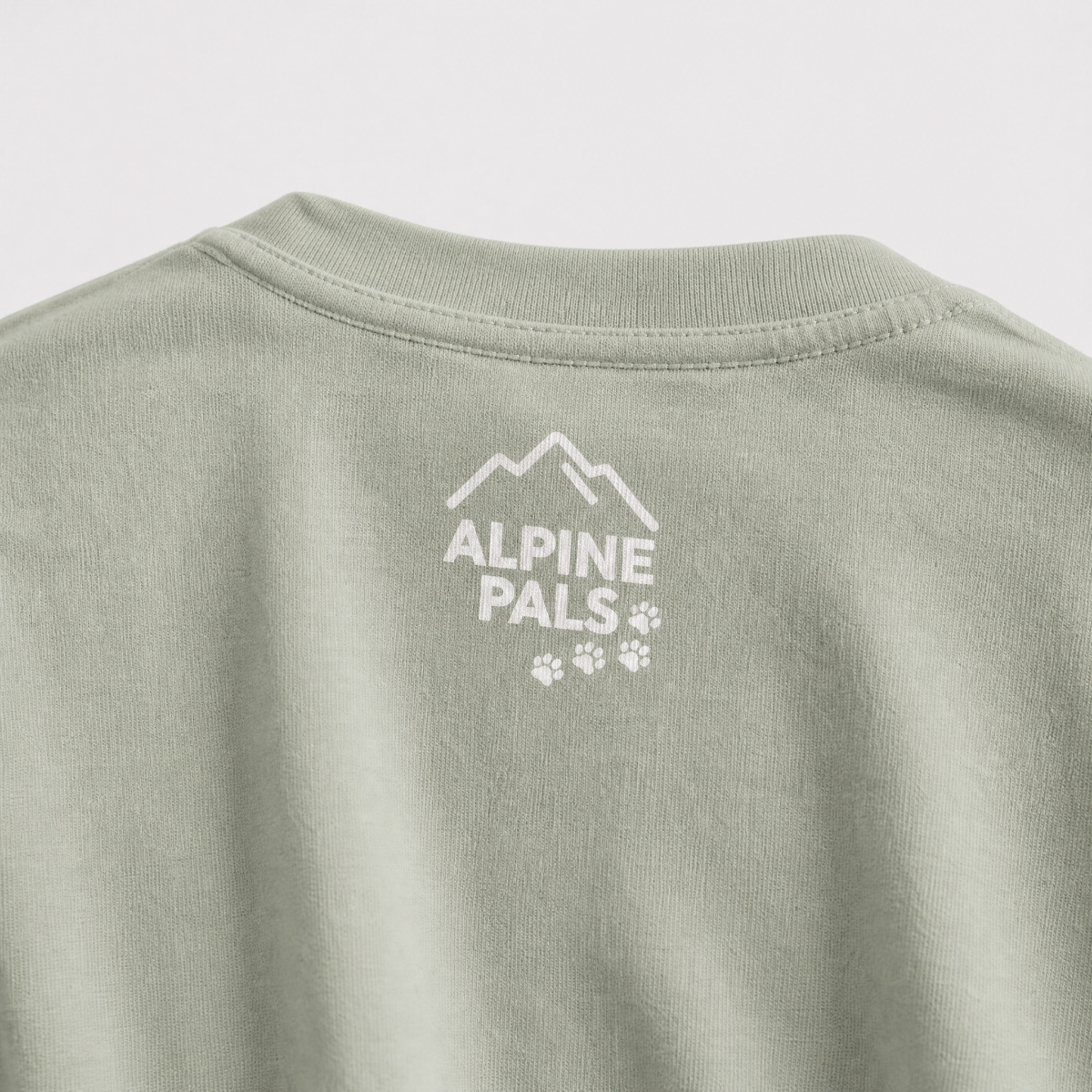 Green shirt with 'Alpine Pals' logo on a light gray background