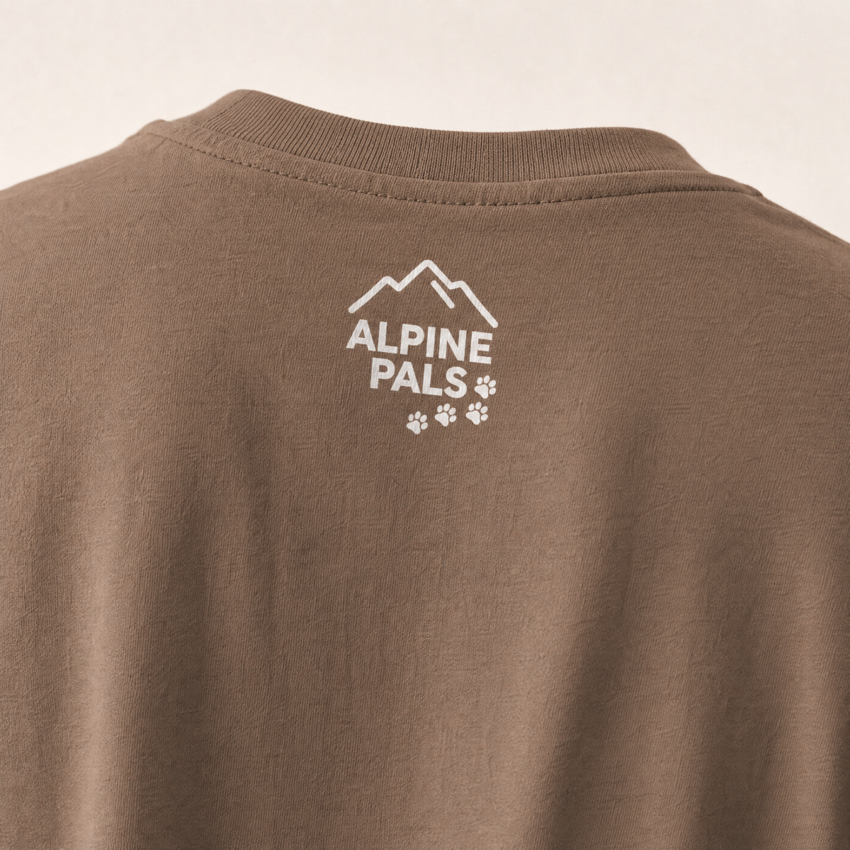 Espresso brown shirt with 'Alpine Pals' logo on a beige background