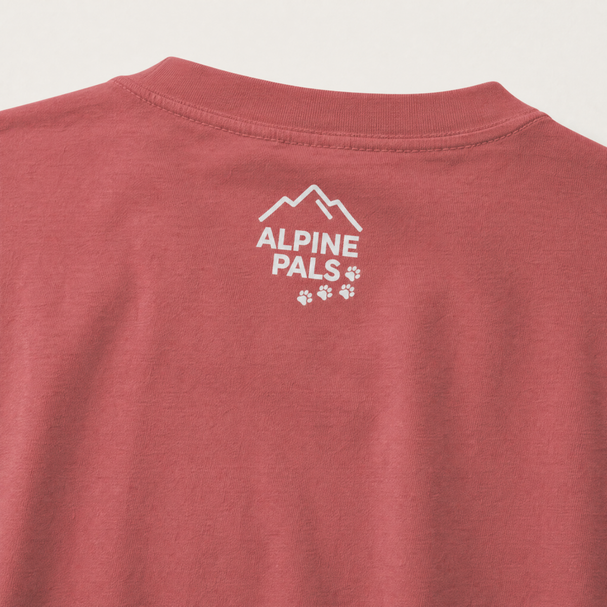 Crimson red shirt with 'Alpine Pals' logo on a light gray background