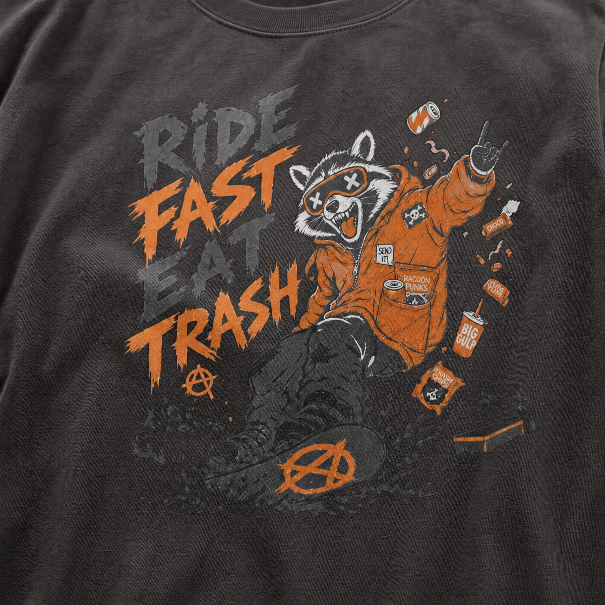 Graphite gray t-shirt with a graphic of a raccoon in an orange jacket and text 'Ride Fast Eat Trash' on a dark background.