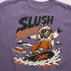 Purple t-shirt with a graphic of a raccoon snowboarding and 'Slush Season' text on a white background.