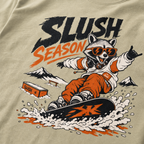 T-shirt with a raccoon snowboarding graphic and 'Slush Season' text on a Khaki background