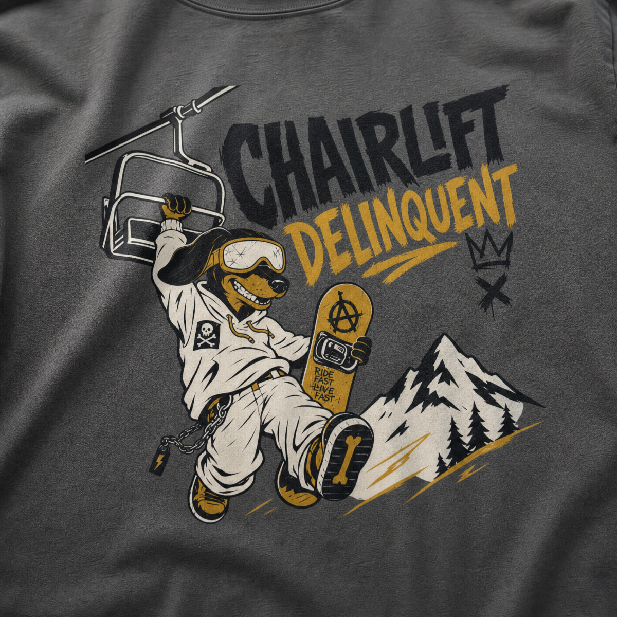 Pepper gray t-shirt with a graphic of a dog on skis, chairlift, and mountain, with 'Chairlift Delinquent' text.