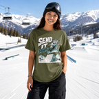 Person wearing a green t-shirt with a graphic design in a snowy mountain setting