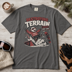 Pepper gray t-shirt with graphic design on a wooden surface with accessories.