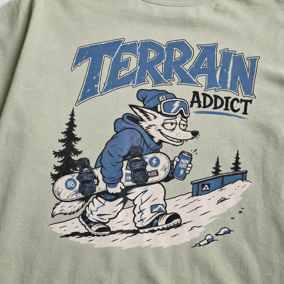 T-shirt with a graphic of a snowboarding fox and 'Terrain Addict' text on a light green background.