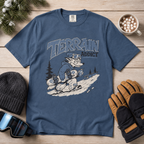 Midnight blue t-shirt with 'Terrain Addict' graphic on a wooden surface with winter accessories.