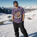Person wearing a purple t-shirt with a graphic design in a snowy mountain setting