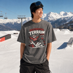 Person wearing a graphic t-shirt with a mountainous background