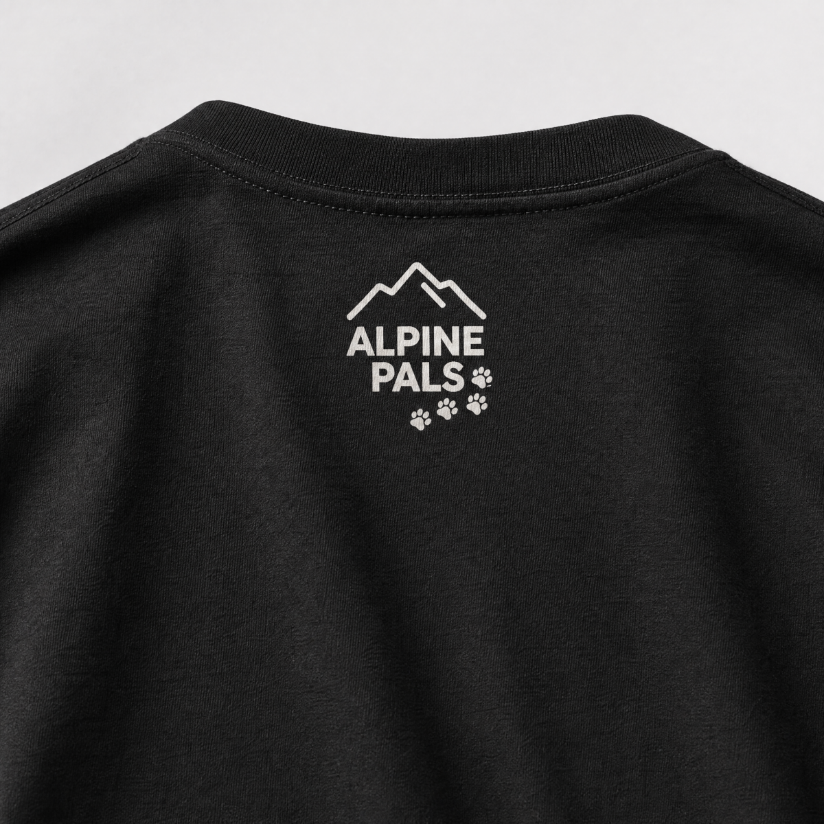 Black shirt with 'Alpine Pals' logo on a light gray background