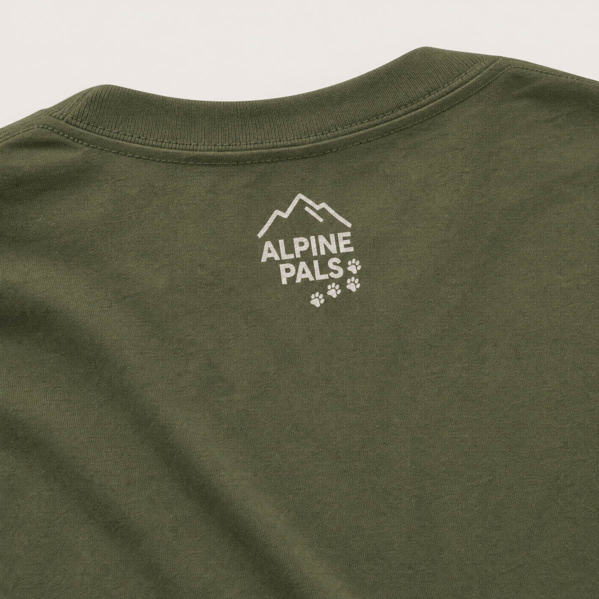Hemp green t-shirt with 'Alpine Pals' logo on a light gray background