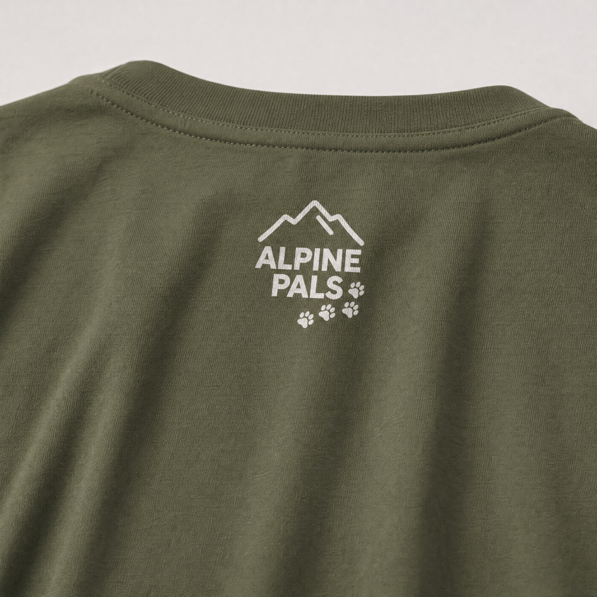 Green t-shirt with 'Alpine Pals' logo on a white background
