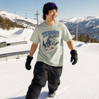 Person wearing a 'Terrain Addict' t-shirt on a snowy slope with mountains in the background