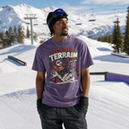 Person wearing a purple t-shirt with graphic design in a snowy mountain setting