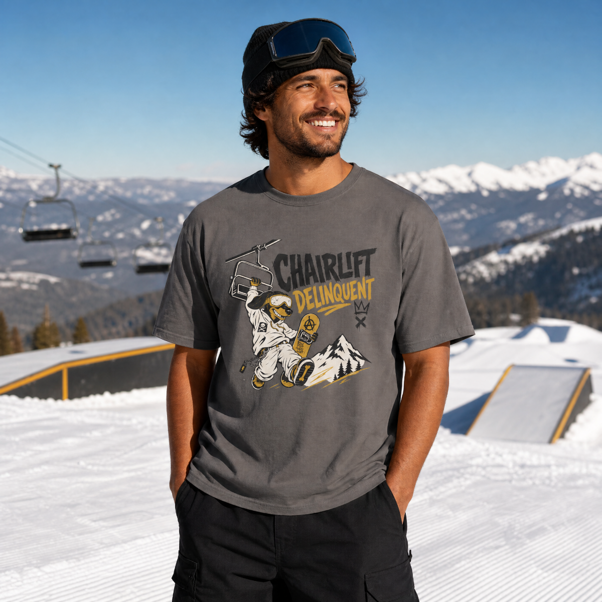 Man wearing a graphic t-shirt with a mountain design on a snowy slope