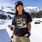 Person wearing a black t-shirt with graphic design in a snowy mountain setting