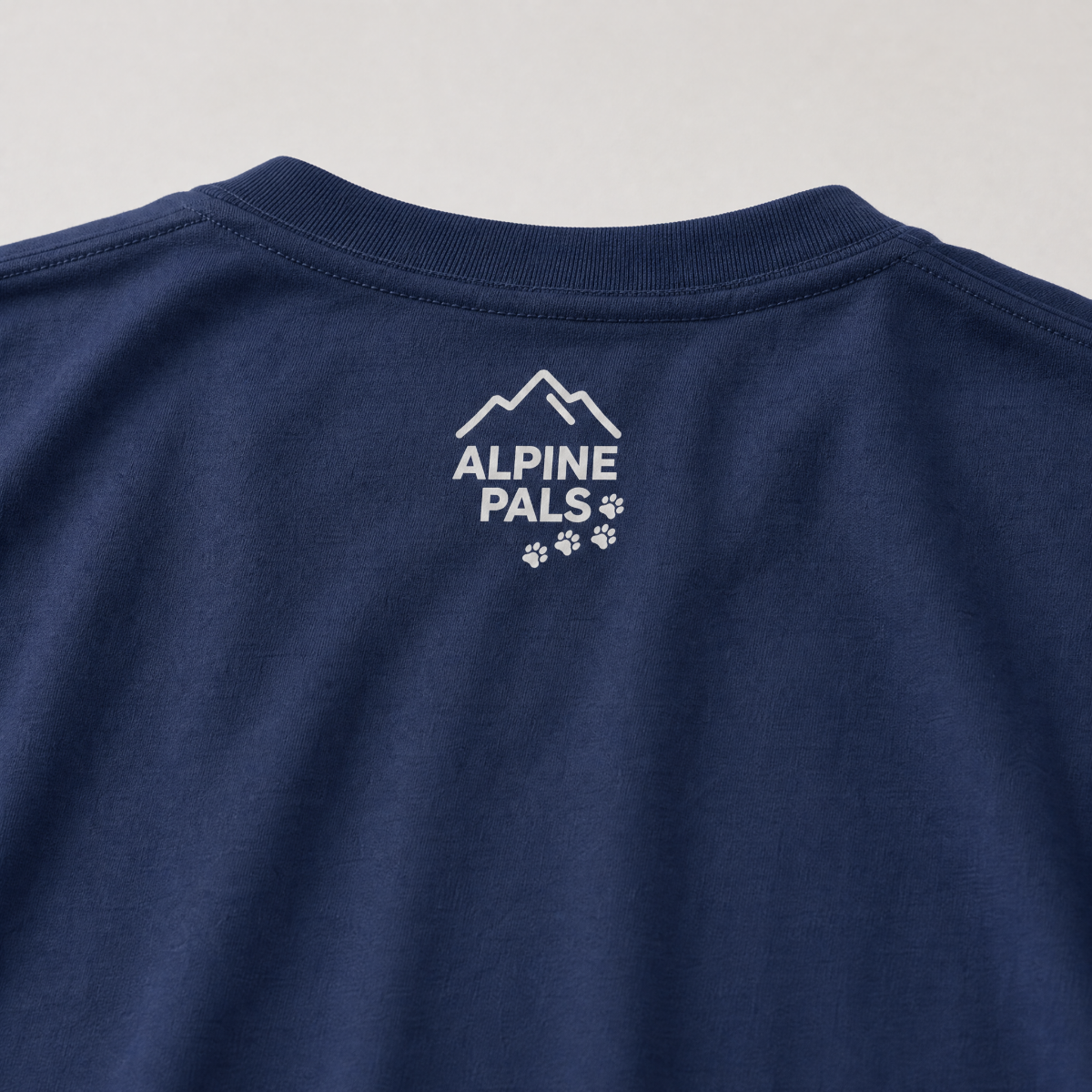 Navy blue shirt with 'Alpine Pals' logo on a light gray background