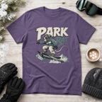 Purple t-shirt with 'Park Rat' graphic on a wooden surface with winter accessories.