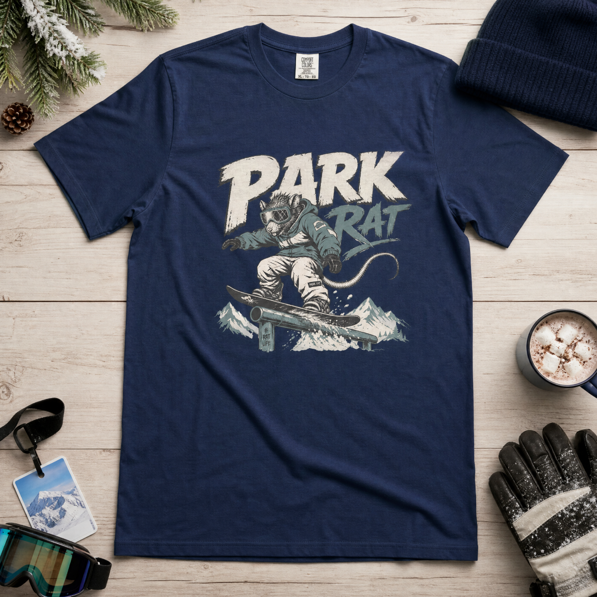 Navy blue t-shirt with 'Park Rat' graphic on a wooden surface with winter accessories.