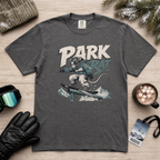 Pepper gray t-shirt with 'Park Rat' graphic on a wooden surface with winter accessories.