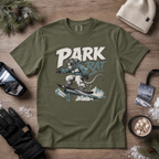 Hemp green t-shirt with 'Park Rat' graphic on a wooden surface with winter accessories.