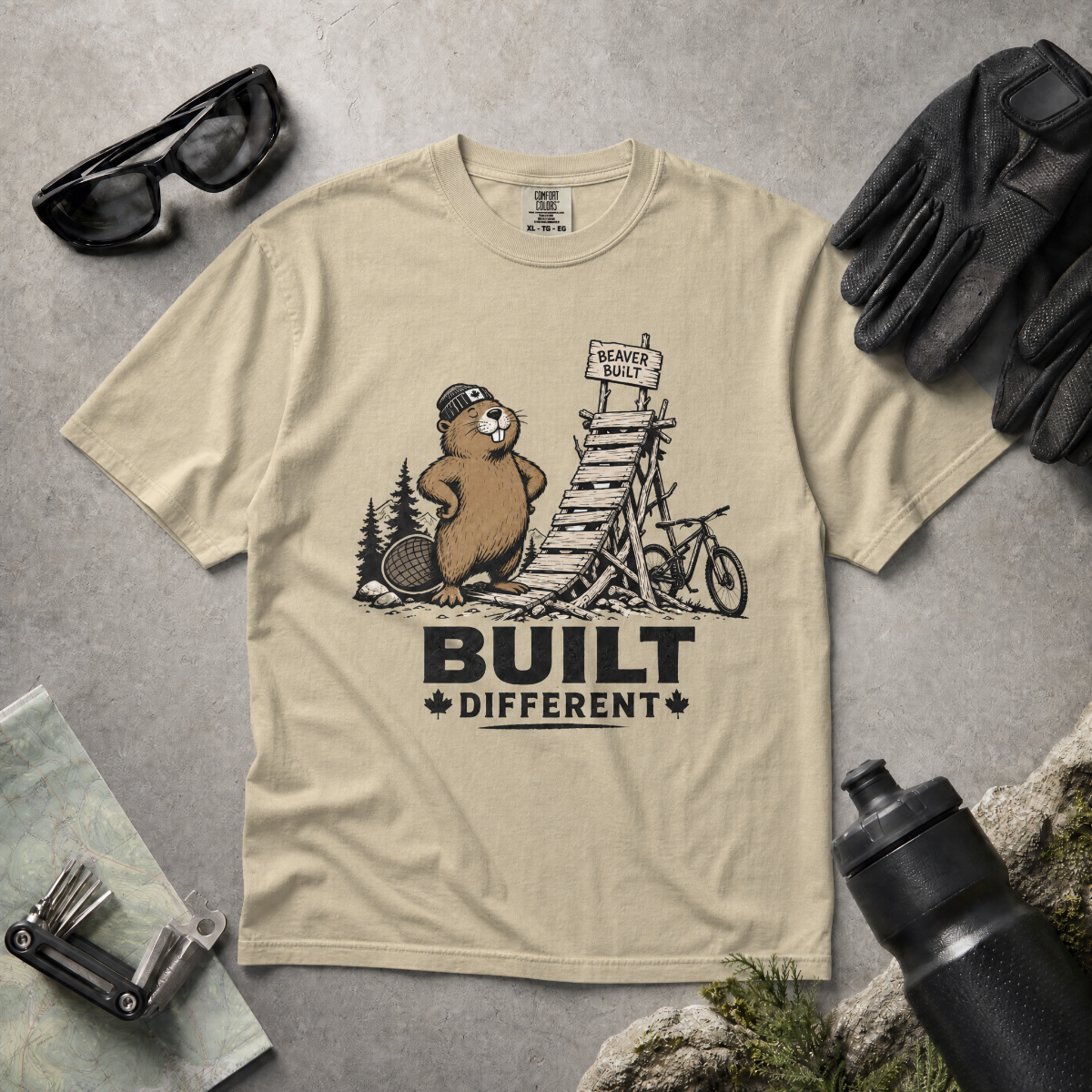 Khaki colored t-shirt with beaver graphic and 'Built Different' text.