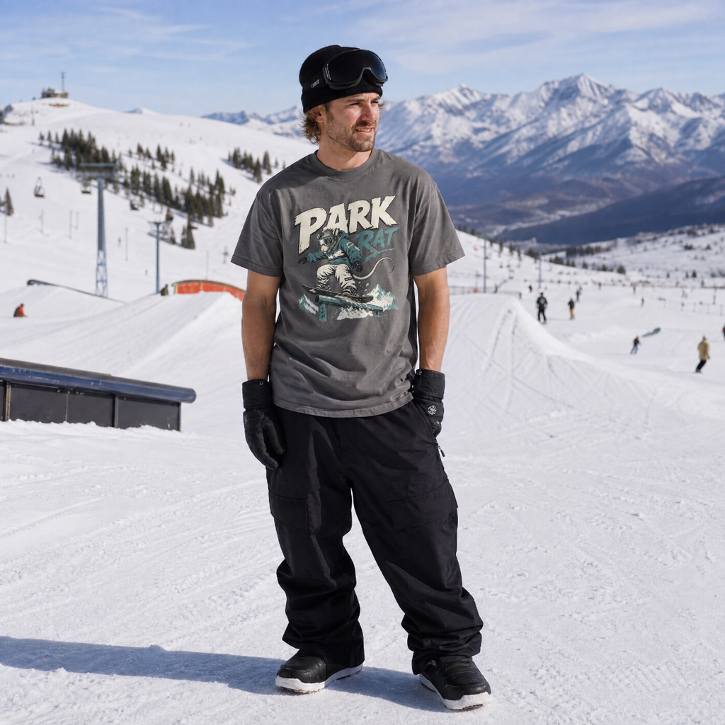 Person wearing a pepper gray t-shirt with 'PARK RAT' written on it.