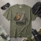 Moss green t-shirt with beaver graphic and 'Built Different' text on a white background