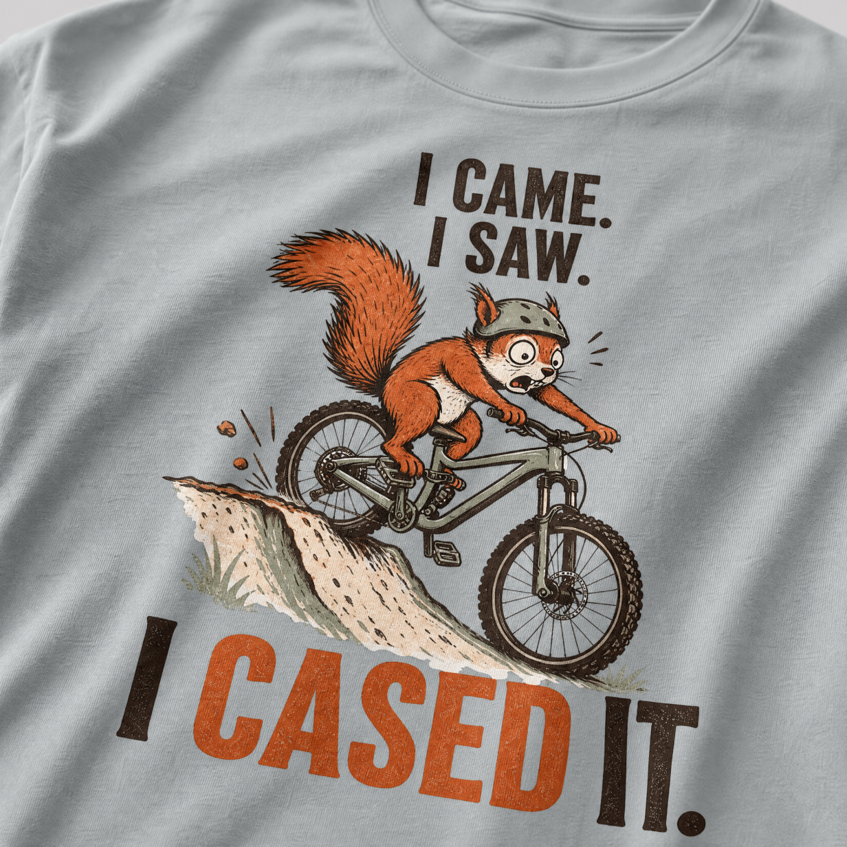 Granite gray t-shirt with a graphic of a squirrel on a bike and text 'I Came. I Saw. I Cased It.'
