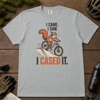 Granite gray t-shirt with a graphic of a squirrel on a bike and text 'I Came. I Saw. I Cased It.' on a wooden surface.