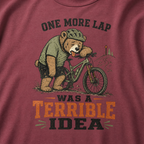 Brick red t-shirt with a bear riding a bike graphic and text 'One more lap was a terrible idea'.