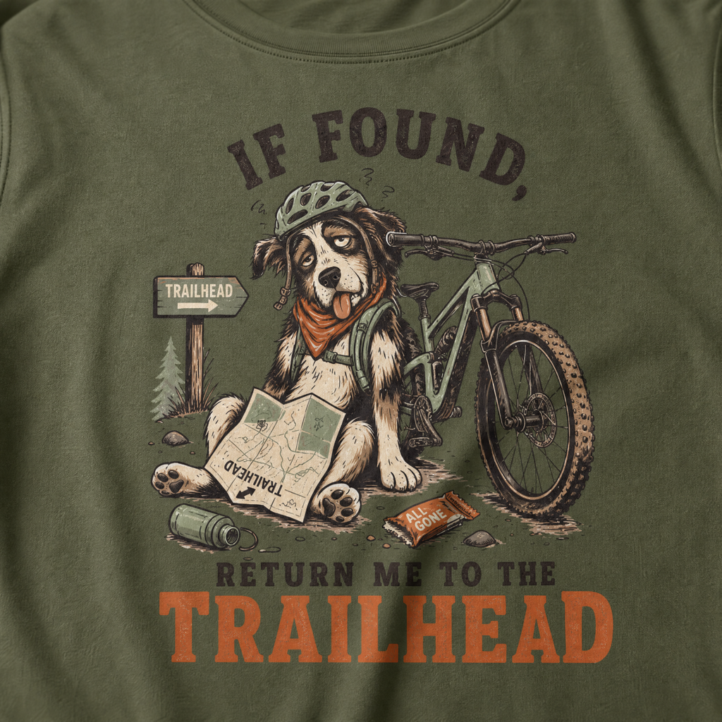 Hemp green t-shirt with a graphic of a dog with a bicycle and text 'If found, return me to the trailhead'.